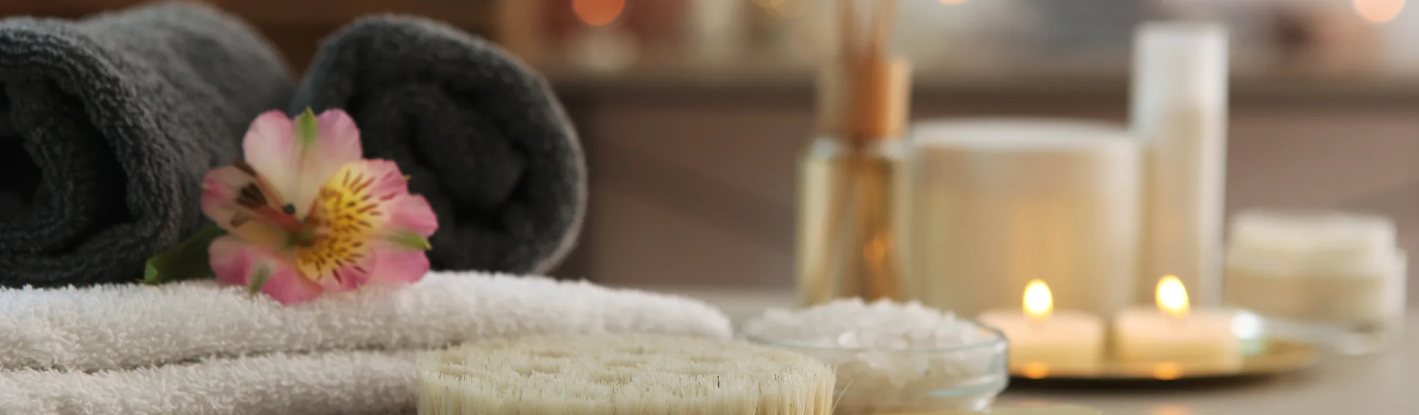 Relaxing spa setting with candles and towels at Sugar Deeva